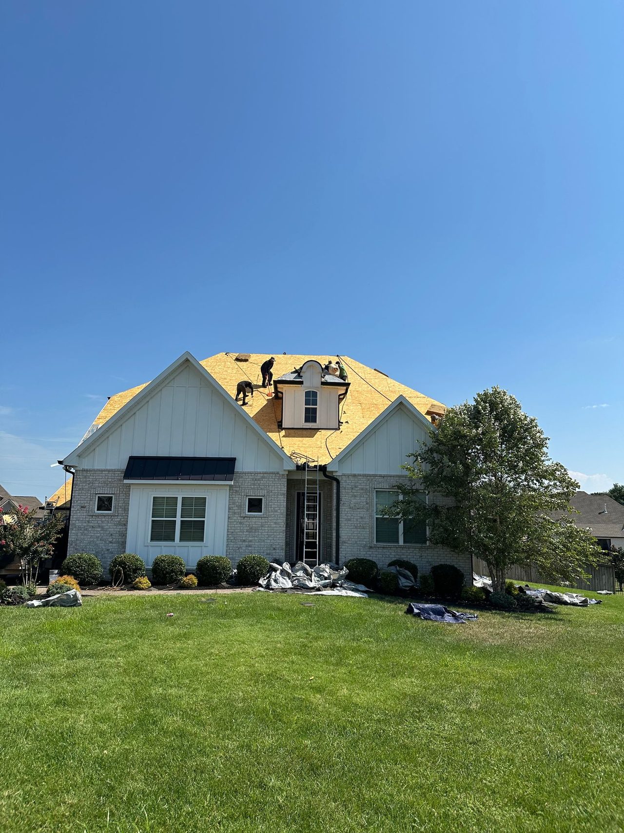 Crew decking a new roof, Gallatin