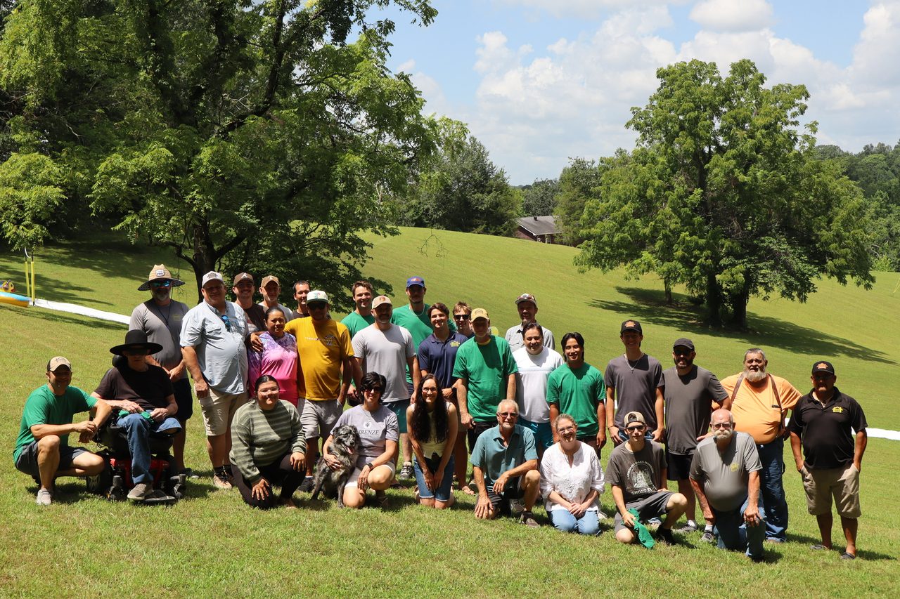 The Cross Driven Construction crew, about thirty people, gathered outdoors on a summer afternoon