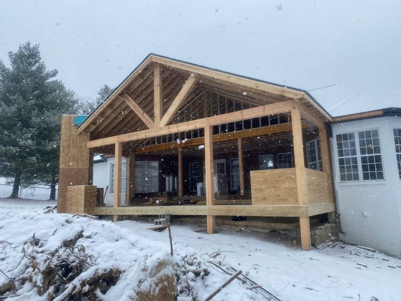 Framing going up on a covered porch addition